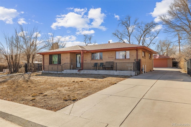 single story home with a garage and an outbuilding