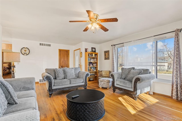 living room featuring ceiling fan and light hardwood / wood-style floors