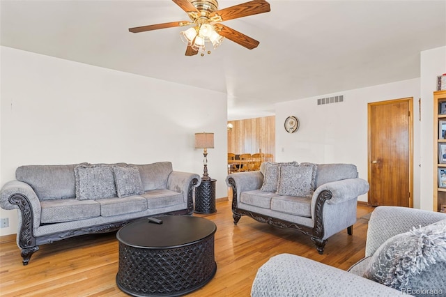 living room with hardwood / wood-style flooring and ceiling fan