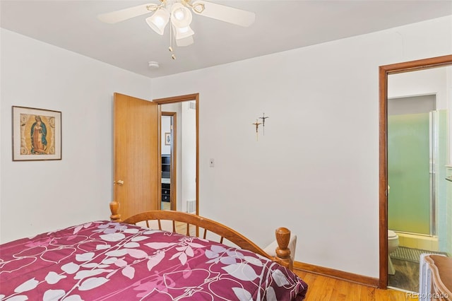 bedroom with ceiling fan, connected bathroom, and light hardwood / wood-style floors