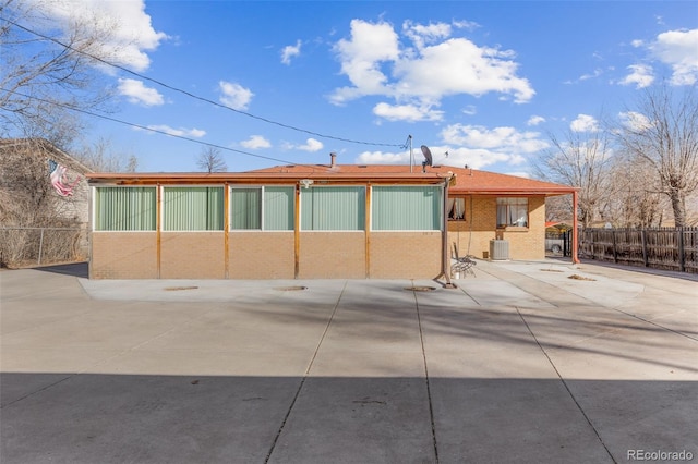 rear view of house featuring central AC and a patio