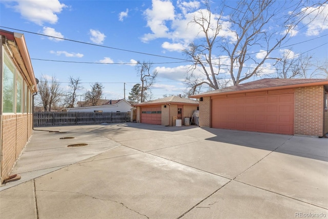 view of front of property featuring a garage and an outdoor structure