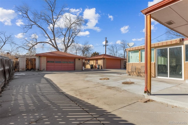 exterior space with a garage and an outdoor structure