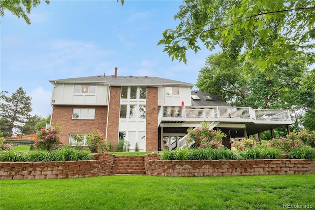 7330 Routt St, Arvada, CO 80005 - rear view of property with a wooden deck, a lawn, and brick siding