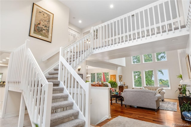 7330 Routt St, Arvada, CO 80005 - stairs featuring a high ceiling, wood finished floors, and recessed lighting
