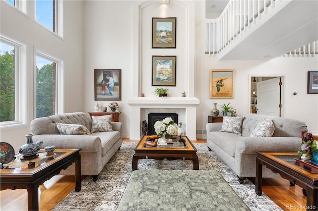 7330 Routt St, Arvada, CO 80005 - living area featuring a high ceiling, a fireplace, and wood finished floors