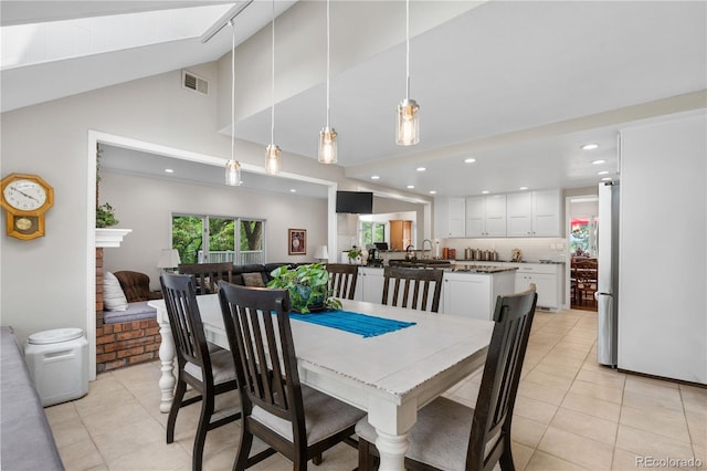 7330 Routt St, Arvada, CO 80005 - dining area with light tile patterned floors, high vaulted ceiling, and recessed lighting