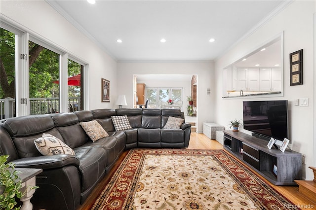 7330 Routt St, Arvada, CO 80005 - living area featuring wood finished floors, recessed lighting, and ornamental molding