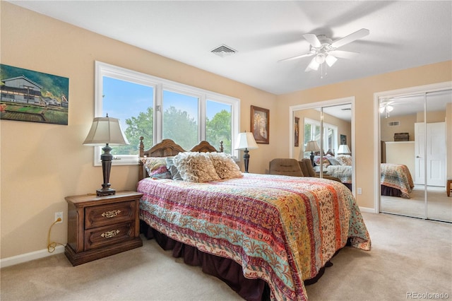 7330 Routt St, Arvada, CO 80005 - bedroom with two closets, light colored carpet, and ceiling fan