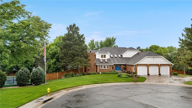 7330 Routt St, Arvada, CO 80005 - traditional-style house with an attached garage, concrete driveway, and brick siding