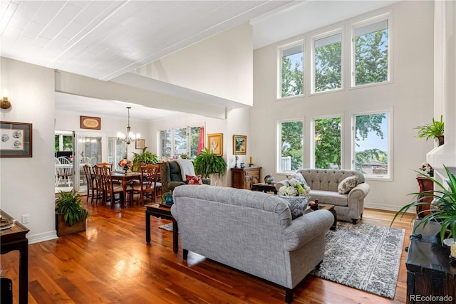 7330 Routt St, Arvada, CO 80005 - living area with a chandelier, wood finished floors, and a high ceiling