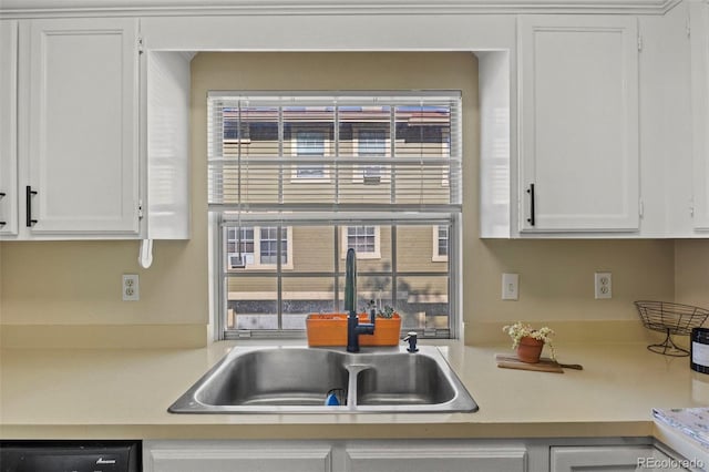 kitchen featuring a sink, light countertops, plenty of natural light, and white cabinets
