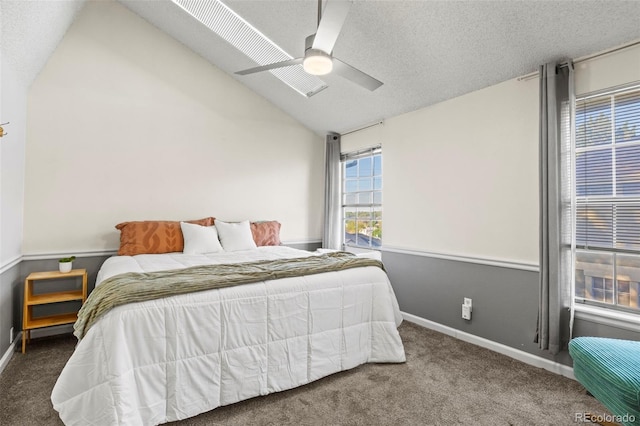 bedroom featuring carpet floors, lofted ceiling, a ceiling fan, baseboards, and a textured ceiling