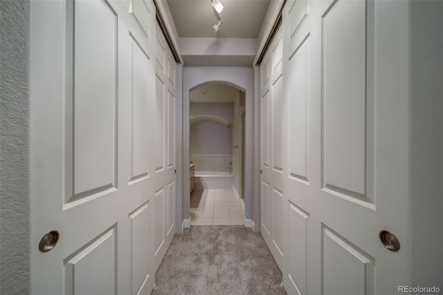 corridor with light tile patterned flooring