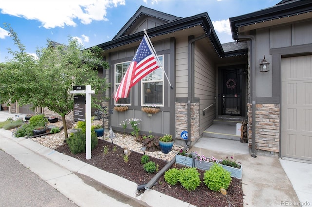 11823 Barrentine Loop, Parker, CO 80138 - view of exterior entry with an attached garage, board and batten siding, and stone siding