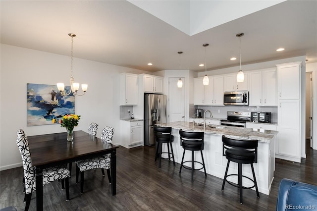11823 Barrentine Loop, Parker, CO 80138 - kitchen with appliances with stainless steel finishes, dark wood-style flooring, a chandelier, and recessed lighting