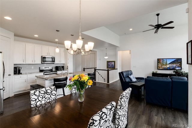 11823 Barrentine Loop, Parker, CO 80138 - dining area featuring dark wood-type flooring, ceiling fan, a chandelier, and recessed lighting