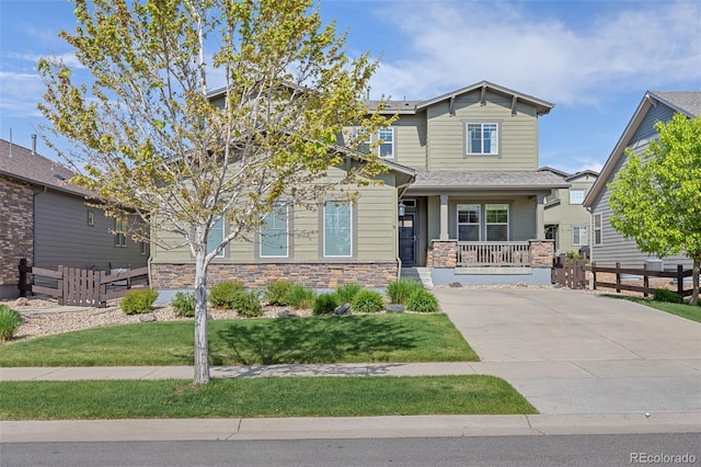 525 Grenville Cir, Erie, CO 80516 - craftsman house with covered porch, stone siding, and driveway
