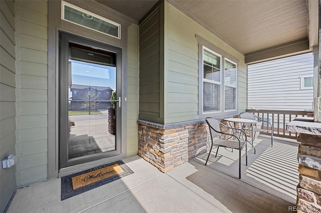 525 Grenville Cir, Erie, CO 80516 - view of exterior entry with a porch and stone siding