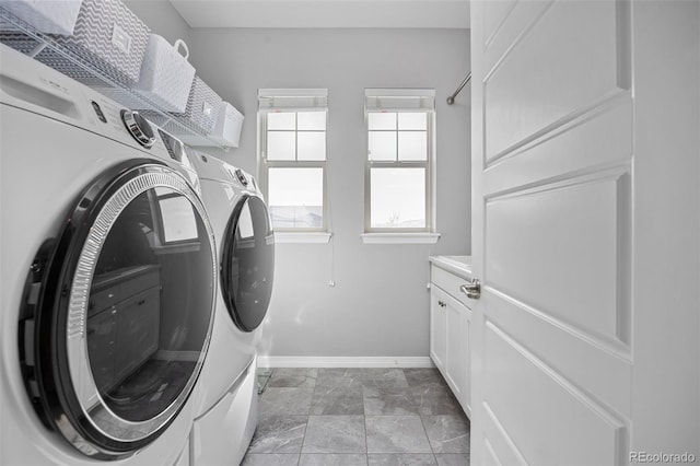 525 Grenville Cir, Erie, CO 80516 - laundry room with washing machine and clothes dryer, baseboards, and cabinet space