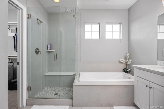 525 Grenville Cir, Erie, CO 80516 - full bath with a shower stall, vanity, a spacious closet, and a bath