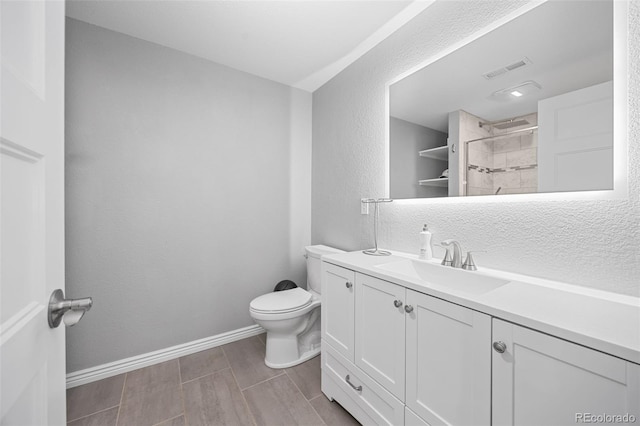 525 Grenville Cir, Erie, CO 80516 - bathroom with a shower, toilet, a textured wall, vanity, and wood tiled floors