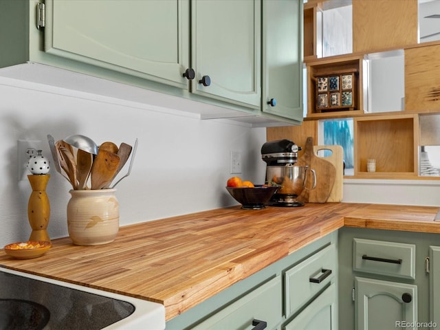 interior space featuring butcher block counters and green cabinetry