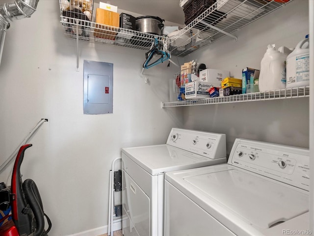 washroom with independent washer and dryer and electric panel