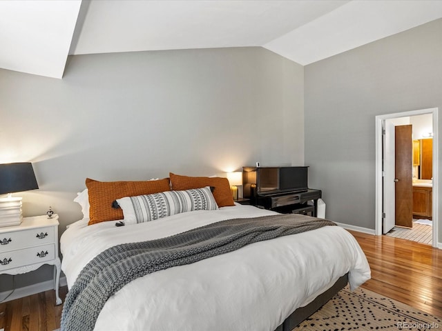 bedroom with light hardwood / wood-style flooring and lofted ceiling