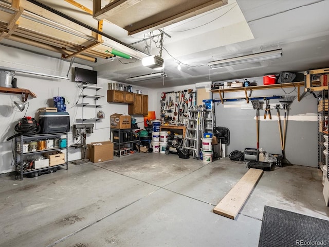 garage with a workshop area and a garage door opener