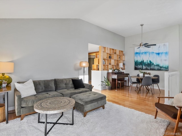 living room with lofted ceiling, ceiling fan, radiator, and hardwood / wood-style floors