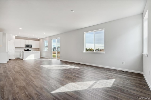 unfurnished living room with hardwood / wood-style floors