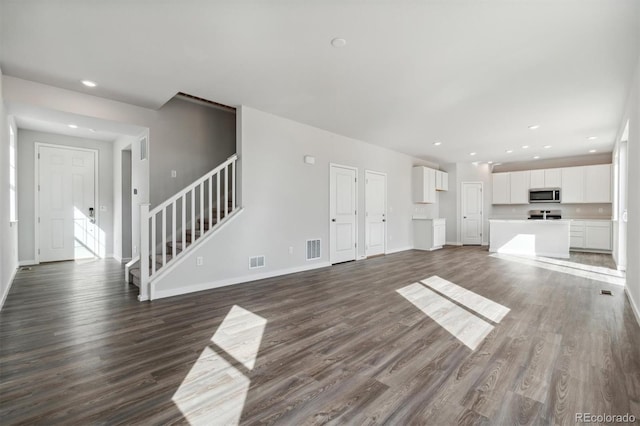 unfurnished living room featuring dark hardwood / wood-style flooring