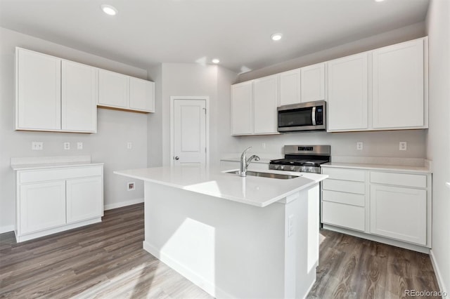 kitchen with white cabinetry, appliances with stainless steel finishes, and a center island with sink