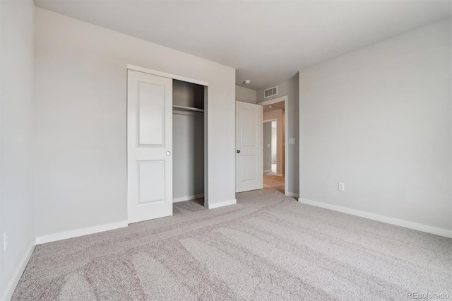 unfurnished bedroom featuring carpet floors and a closet