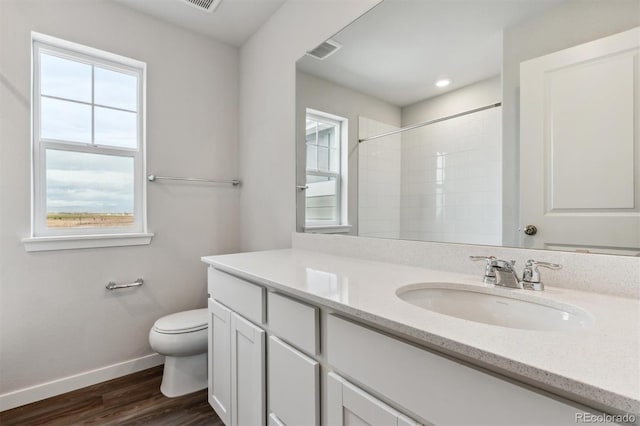 bathroom with vanity, a shower, wood-type flooring, and toilet