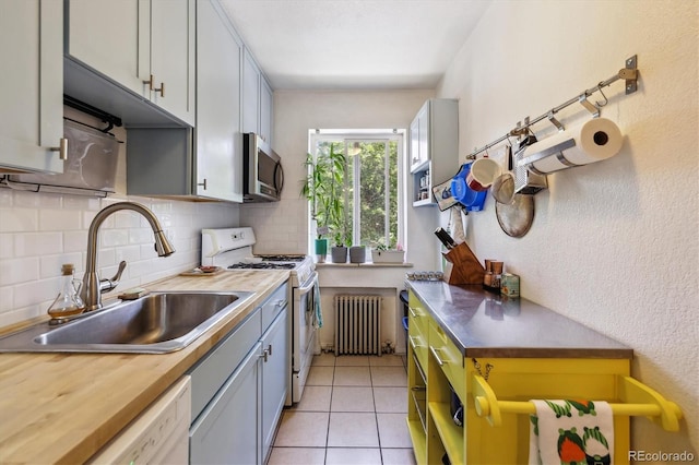 85 N Grant St Unit 28, Denver, CO 80203 - kitchen featuring radiator, a sink, white appliances, butcher block counters, and backsplash