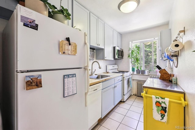85 N Grant St Unit 28, Denver, CO 80203 - kitchen featuring white appliances, a sink, radiator, backsplash, and white cabinets
