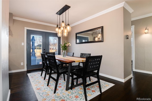 dining room with ornamental molding, wood finished floors, and baseboards