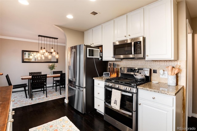 kitchen featuring white cabinetry, visible vents, stainless steel appliances, and decorative backsplash