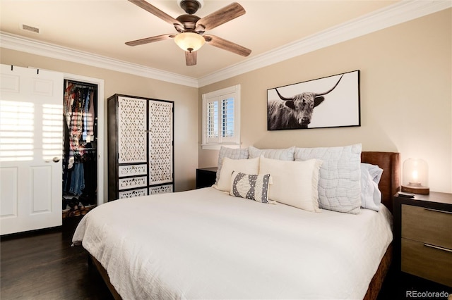 bedroom featuring ceiling fan, visible vents, dark wood finished floors, and crown molding