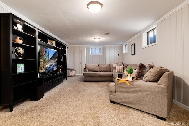 living room with carpet flooring, visible vents, and crown molding