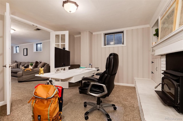 carpeted office featuring visible vents, crown molding, and baseboards