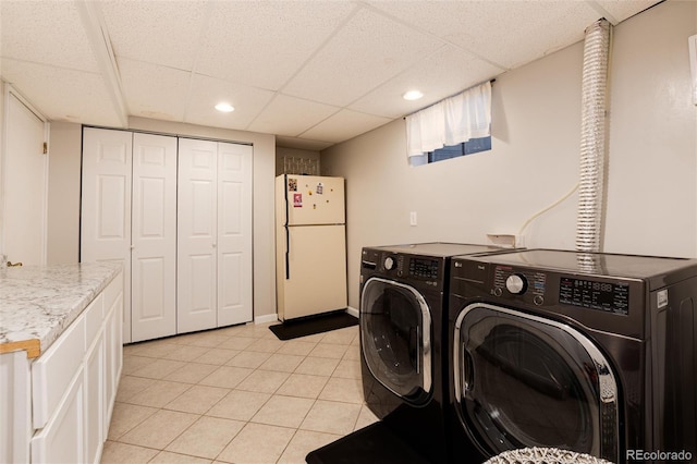 laundry area with laundry area, recessed lighting, light tile patterned floors, and washing machine and clothes dryer