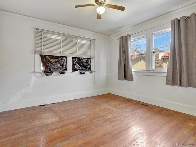 empty room with hardwood / wood-style flooring and ceiling fan