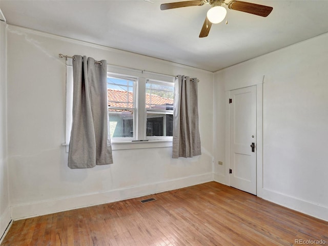 spare room featuring ceiling fan and light hardwood / wood-style floors