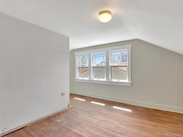 bonus room featuring lofted ceiling and light hardwood / wood-style flooring