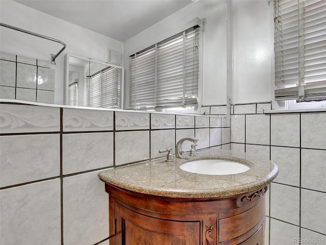 bathroom featuring tile walls and vanity