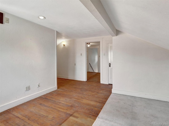 unfurnished room with lofted ceiling and wood-type flooring