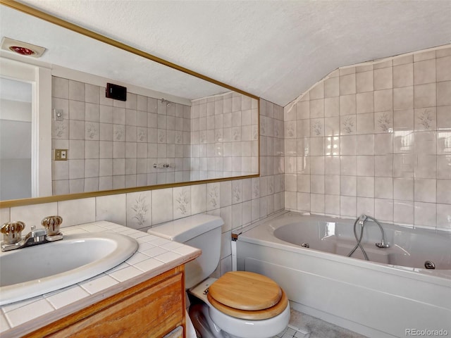 bathroom with vaulted ceiling, tile walls, vanity, toilet, and a textured ceiling